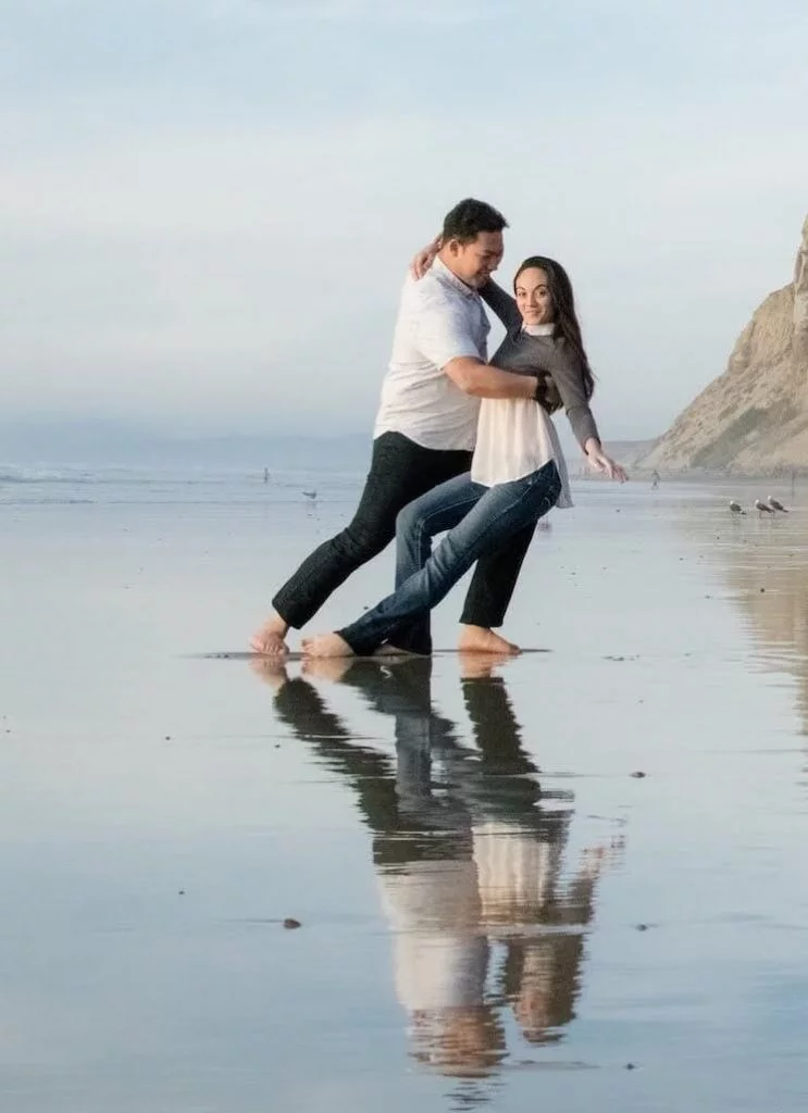 couple dancing west coast swing on beach